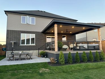 Modern backyard patio with covered seating and outdoor dining area.
