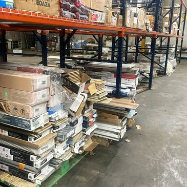 Warehouse shelves stocked with various boxed goods and materials.