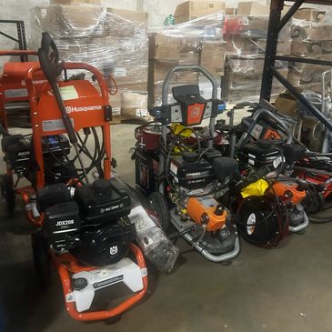 Various Husqvarna construction and landscaping equipment stored indoors.