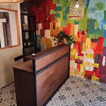 Colorful wall behind a wooden counter in a cozy room.