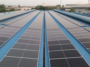 Rows of solar panels on a blue rooftop.