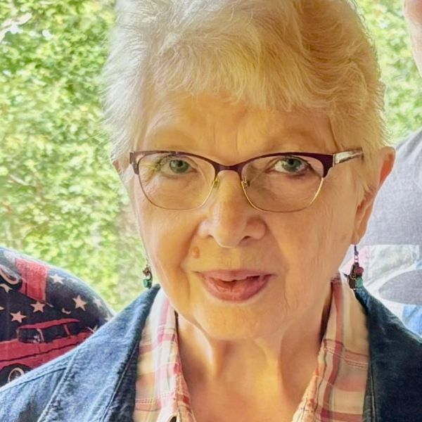 Smiling elderly woman with glasses.