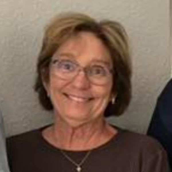 Smiling older woman with glasses.