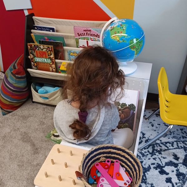 An Explorer reading in our Book Nook at the Art Oasis' ORIGINAL Art Explorers Club in Perkasie PA