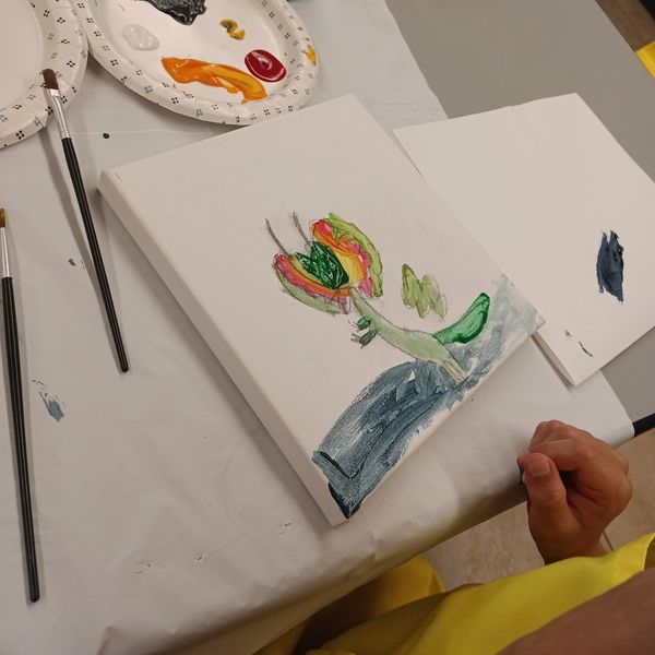 A Student painting a picture of a dinosaur at the Art Oasis' Bright SPARKS program, Perkasie PA