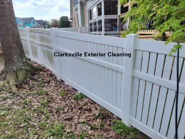 Fence cleaning in progress. Before and after cleaning demonstration.