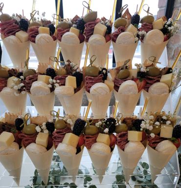 Hand-arranged charcuterie board with cheeses, meats, fruit, and savory snacks.