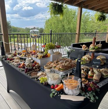 Beautifully arranged charcuterie board featuring cheeses, meats, fruit, and crackers.