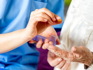 Carer helping with medication after coming from the hospital
