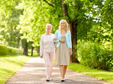 Carer taking a walk with an elderly woman