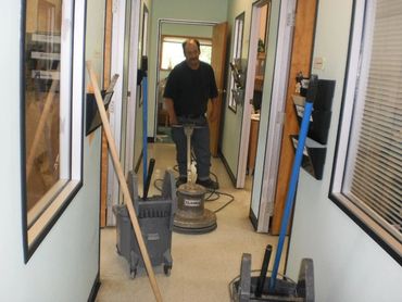 Darcy is stripping and waxing floors.