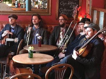 A jazz band are seated in the Argyle Cellar Bar venue in Edinburgh with their instruments.