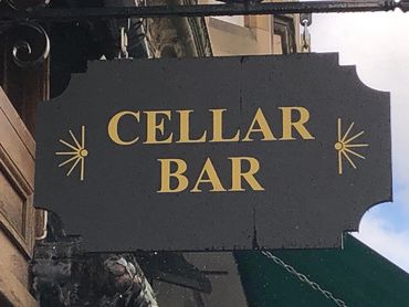 Outdoor signage for the Argyle Cellar Bar, hanging about the doorway at 15 Argyle Place in Marchmont
