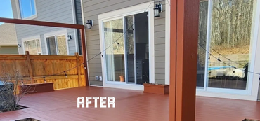 Freshly renovated wooden deck with built-in planters and a hot tub in a backyard.