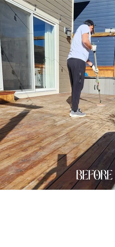 Person cleaning a wooden deck outdoors on a sunny day.