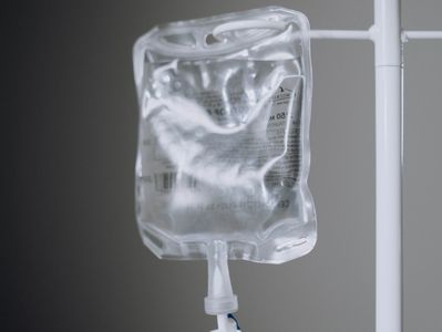 An IV bottle hanging on a hospital stand 