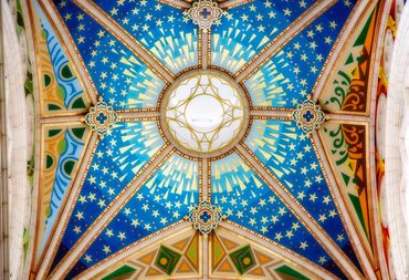 Blue and gold modern ceiling details that include a gold trim and stars on a blue background.