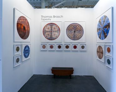 Display of larger and smaller circular photographic images during the Toronto Artist Project. 