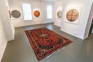 4 large circular persian carpet photographs with a persian rug on the floor