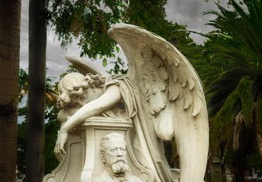 Stone angel slumped over a tumb in the Montevideo cemetery.