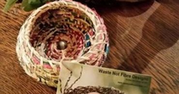 A little coiled basket with a bead in the centre.