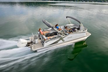 Four people enjoy a ride on an Avalon pontoon boat.
