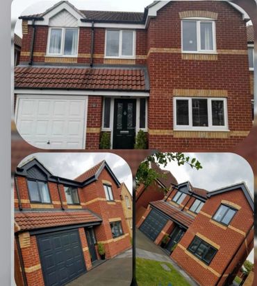 Two modern brick houses with garages and tiled roofs.