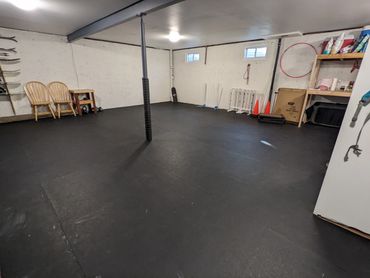 Indoor dog training room with rubber mat flooring and training equipment
