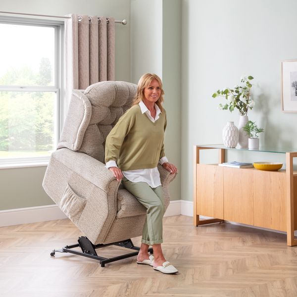 Lady using the riser action on chair