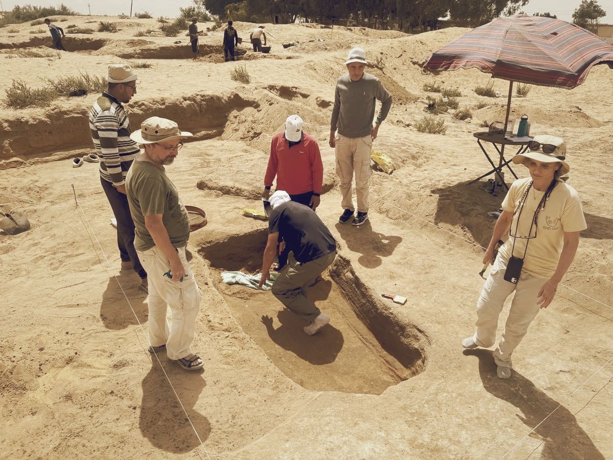 Archaeologists excavating a site in a desert area.