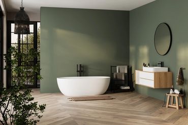 Modern bathroom with a freestanding bathtub and green accent wall.
