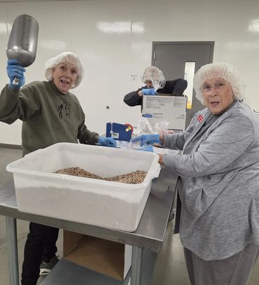 GFWC Idaho members from both Boise Club and Century Club help the Idaho Food Bank by packing 1100 #