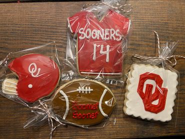 Decorated cookies with Oklahoma Sooners football theme, wrapped in plastic.