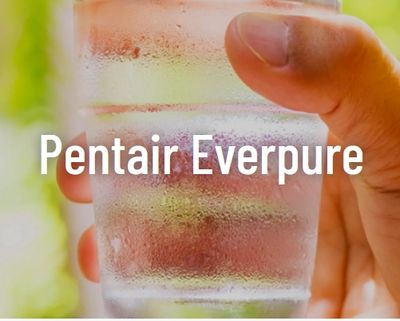 Hand holding a cold glass of water with condensation.