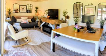 Cozy living room with a workspace and modern decor.