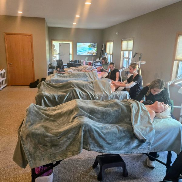 Five people receiving spa treatments in a room.