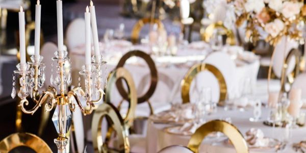 Elegant wedding reception setup with gold and white decor.