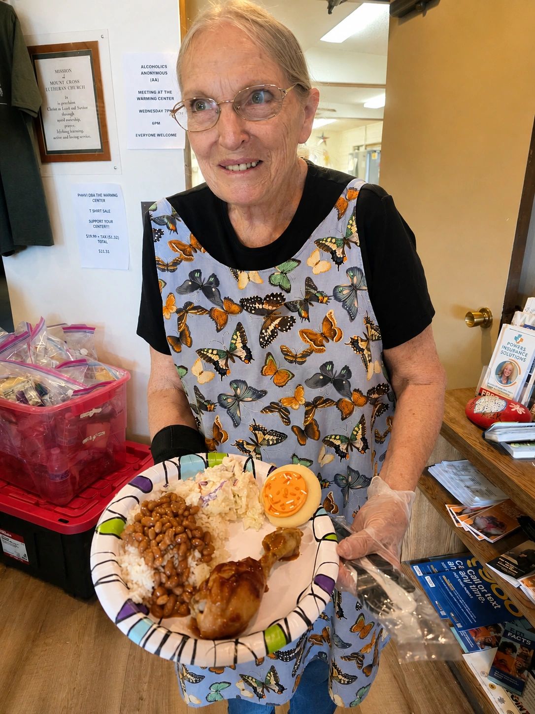 Woman serving food wearing butterfly apron.