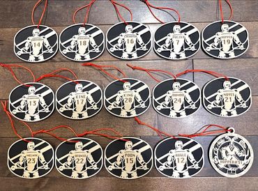 Hockey player ornaments with names and numbers, plus a goalie ornament.