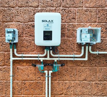 Solar power electrical setup on a brick wall.