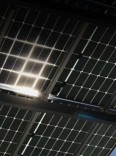 Close-up of solar panels capturing sunlight against a blue sky.