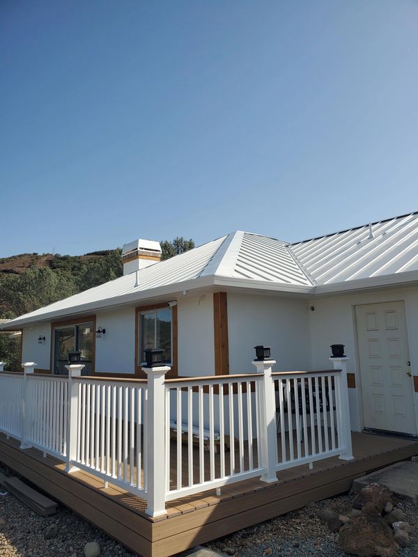 White ASC Skyline metal roof and gutter installation in the Central Valley.