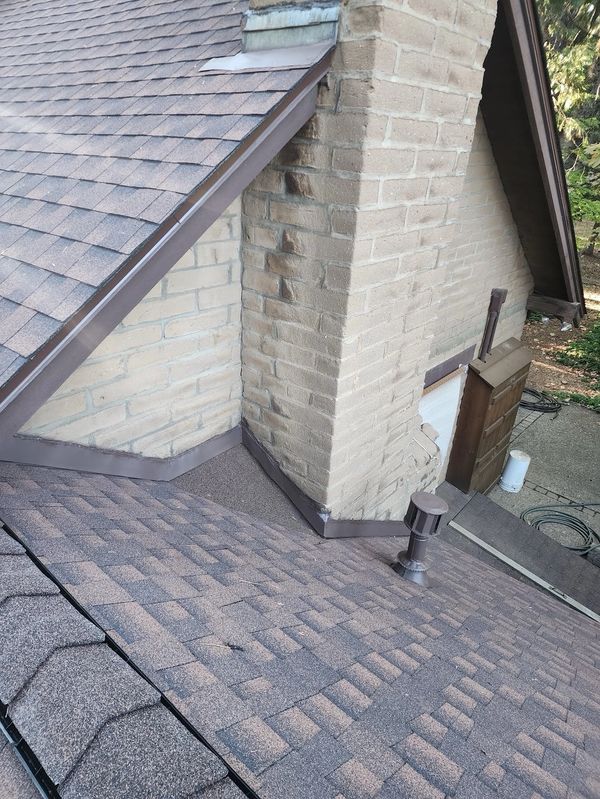 Custom chimney cricket and counter flashing installation in Jamestown, CA.