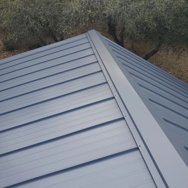 Expert ridge vent cap installation on an Old Zinc Gray metal roof in Twain Harte, CA.