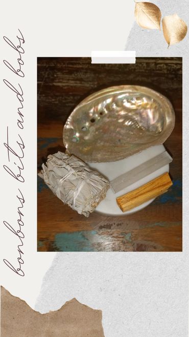 Bundle of sage, palo santo, selenite, and abalone shell for cleansing rituals.
