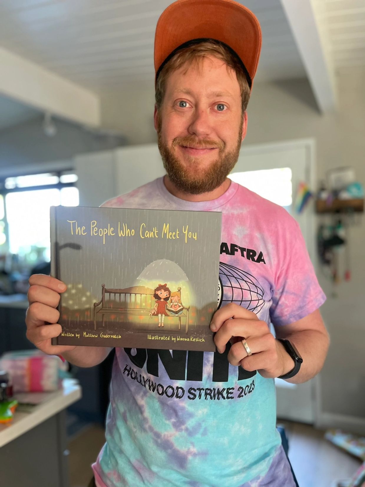 Matt Gudernatch holds his book, The People Who Can't Meet You