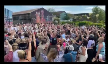 Crowd enjoying an outdoor silent disco event with headphones on.