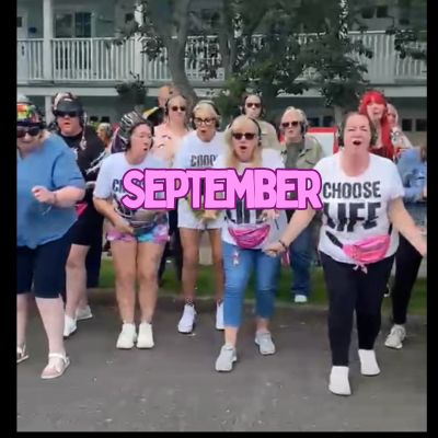 A group of people in festive outfits with pink fanny packs.