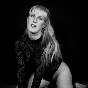Black and white portrait shot of a blonde woman in black lingerie.