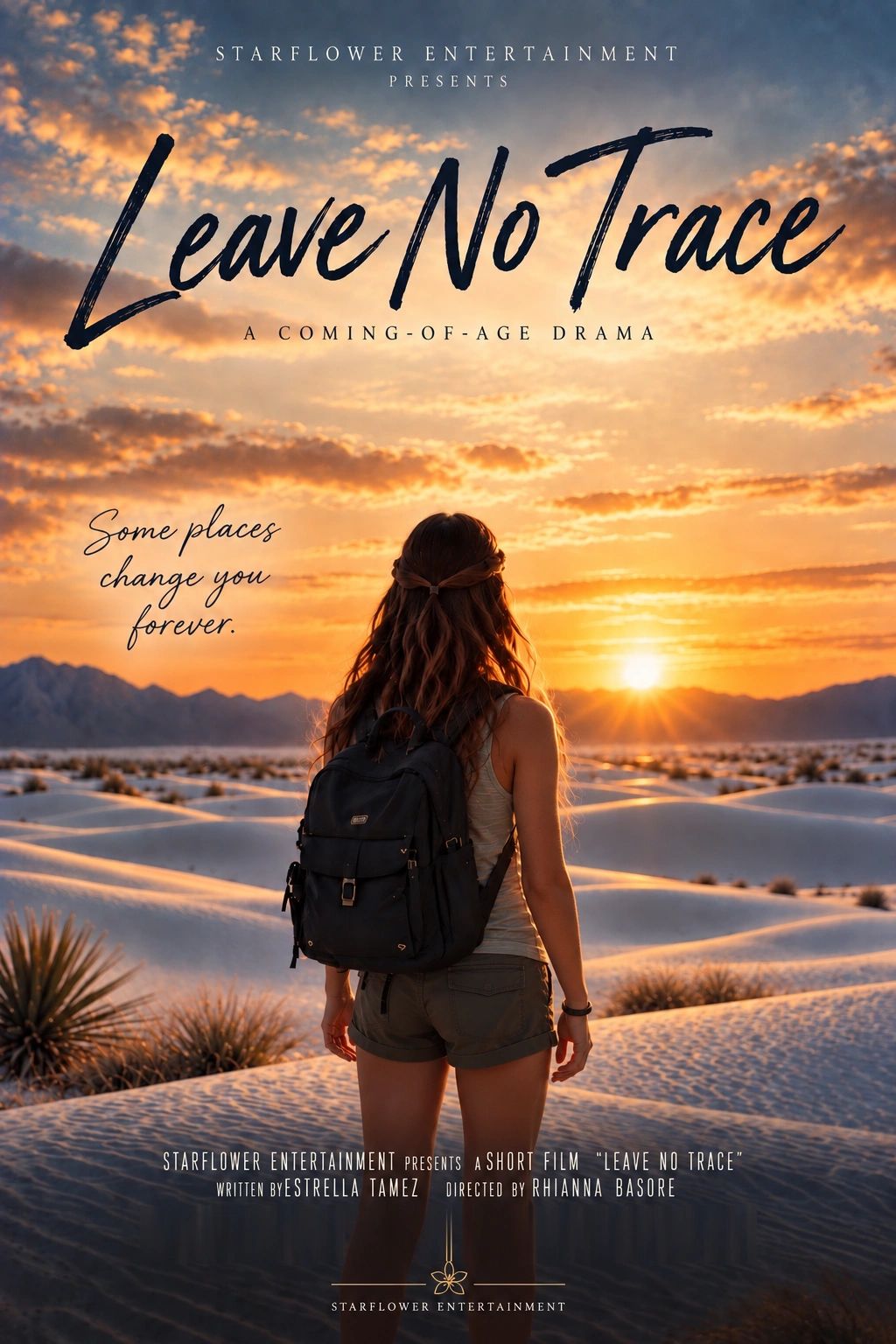 A woman with a backpack watches the sunset over sand dunes.